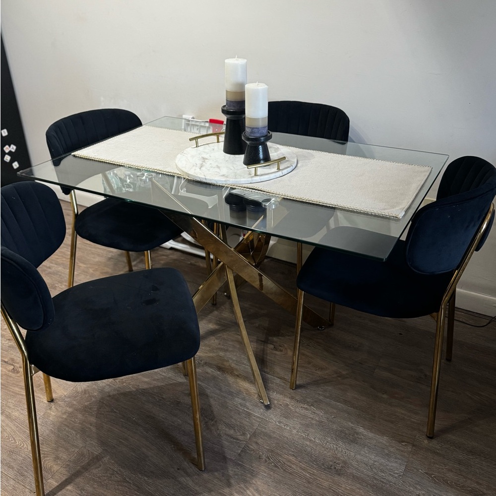 Elegant Glass Dining Table with Black and Gold Chairs